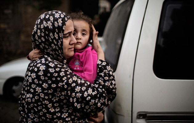 Palästinensische Mutter schützt ihr Kind während eines Luftangriffs 