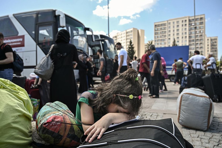 Ein syrisches Mädchen trauert, während sich ihre Landsleute auf die Rückreise von Istanbul nach Syrien vorbereiten